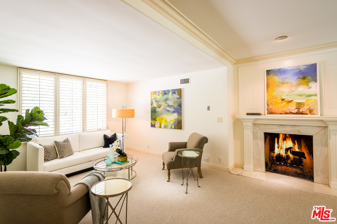 1420 Moraga Drive Los Angeles, CA 90049 - Photo 22 of 38 a living room with furniture and a fireplace