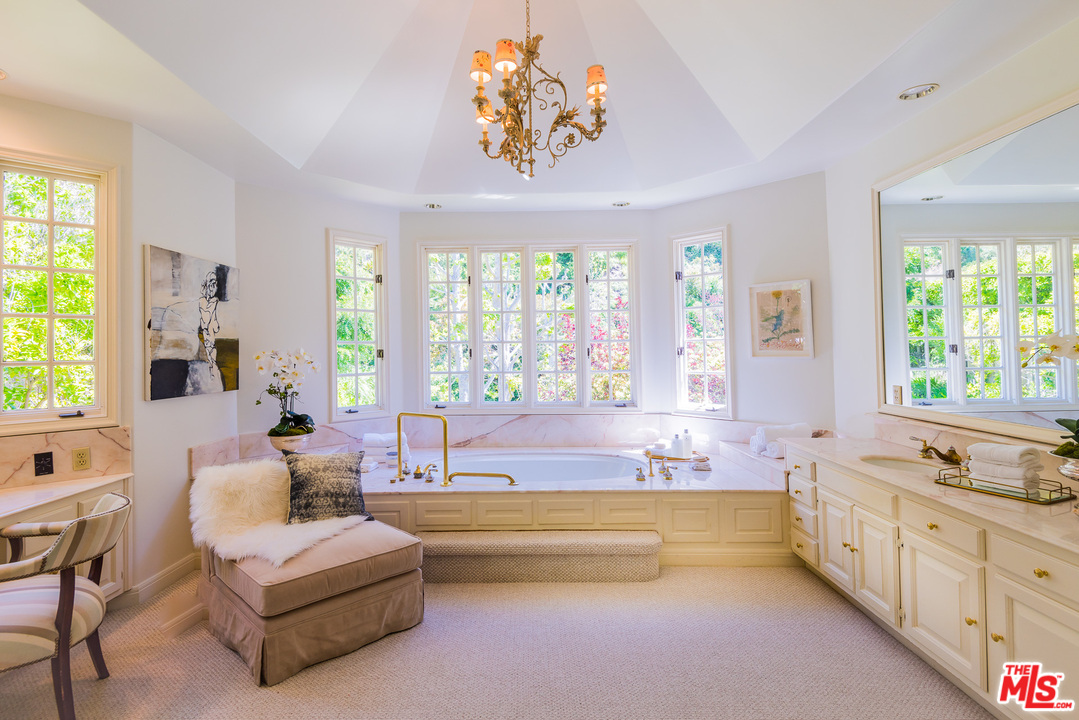 1420 Moraga Drive Los Angeles, CA 90049 - Photo 24 of 38 a spacious en suite bathroom with a tub double vanity and window