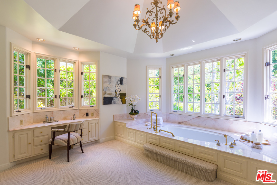1420 Moraga Drive Los Angeles, CA 90049 - Photo 25 of 38 a spacious bathroom with a large tub and large windows