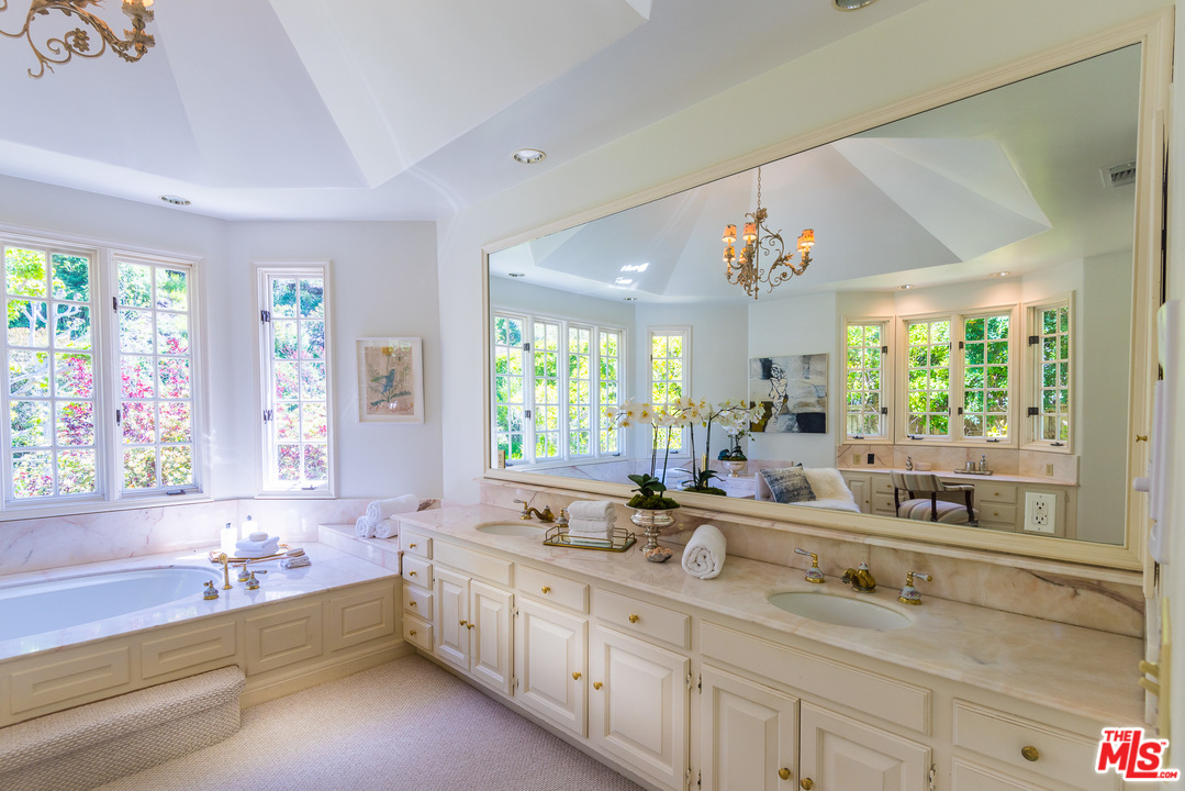 1420 Moraga Drive Los Angeles, CA 90049 - Photo 26 of 38 a large bathroom with a large tub sink and window