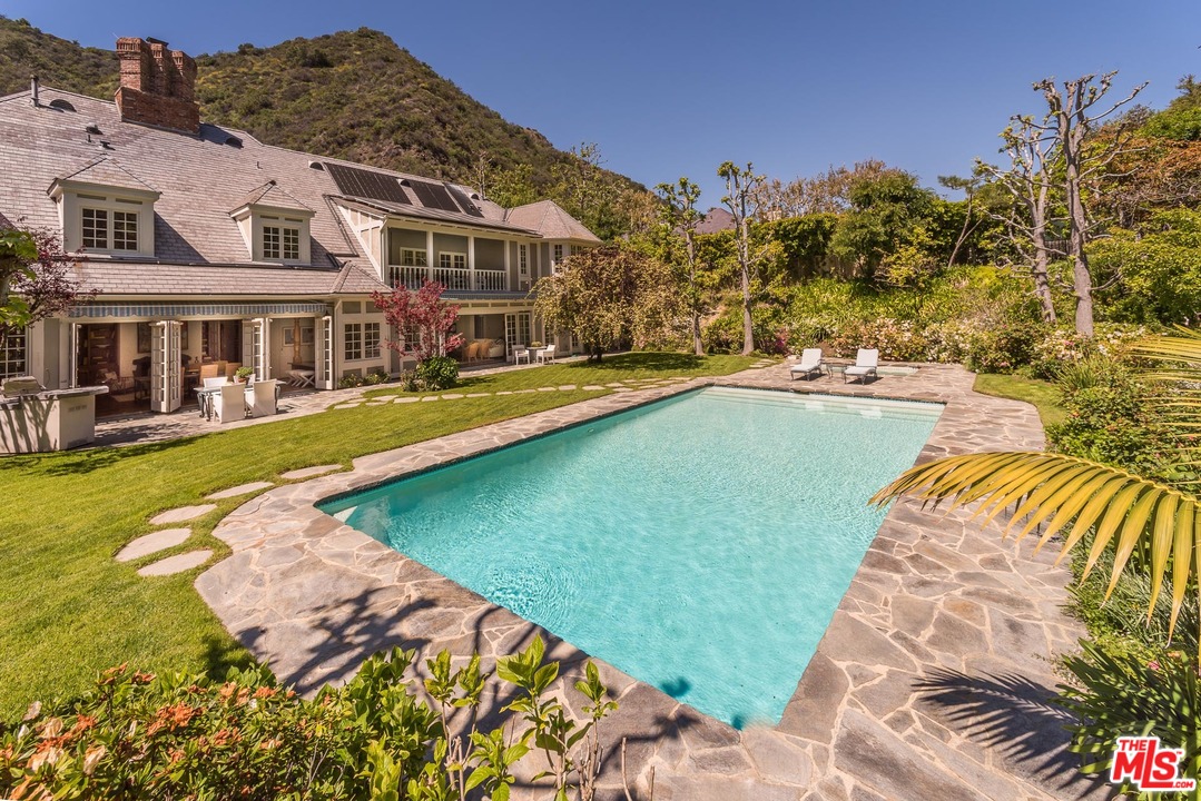 1420 Moraga Drive Los Angeles, CA 90049 - Photo 29 of 38 a view of a swimming pool with lounge chairs