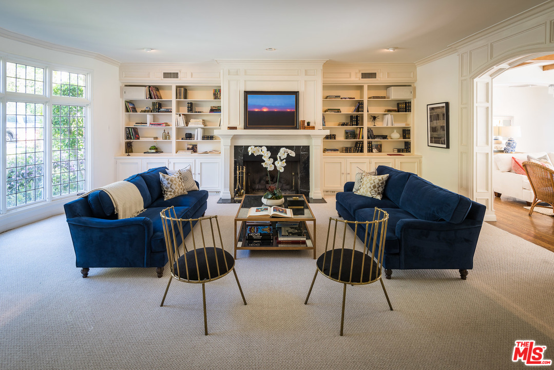 1420 Moraga Drive Los Angeles, CA 90049 - Photo 4 of 38 a living room with furniture and a fireplace