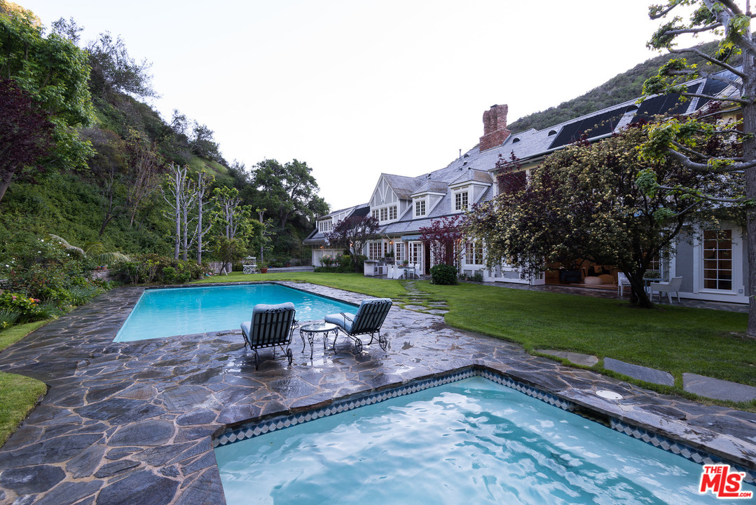 1420 Moraga Drive Los Angeles, CA 90049 - Photo 32 of 38 a view of a yard with a house