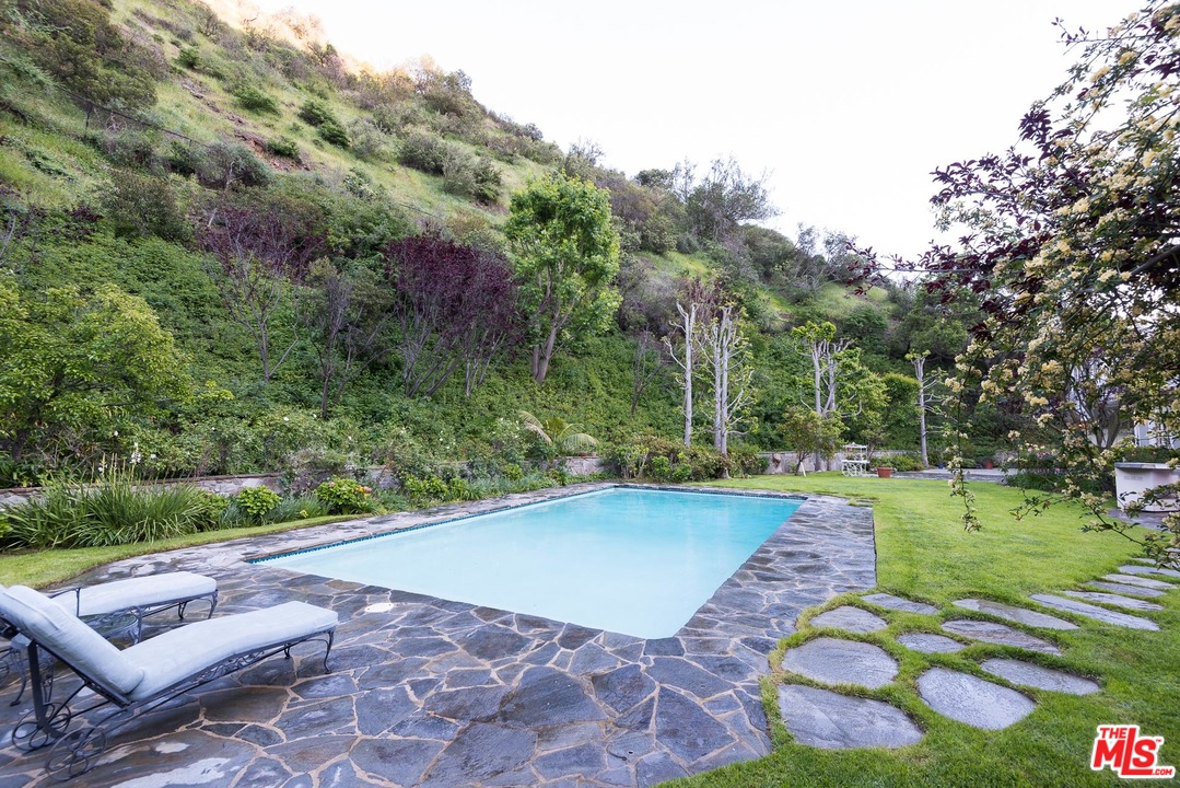 1420 Moraga Drive Los Angeles, CA 90049 - Photo 35 of 38 a view of a backyard with plants and outdoor seating