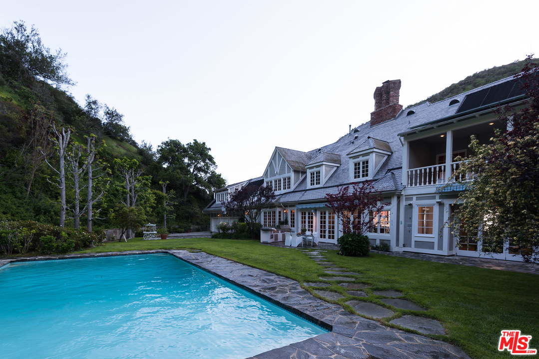 1420 Moraga Drive Los Angeles, CA 90049 - Photo 36 of 38 a view of house with a yard