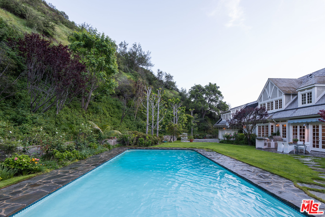 1420 Moraga Drive Los Angeles, CA 90049 - Photo 37 of 38 a view of a house with a yard