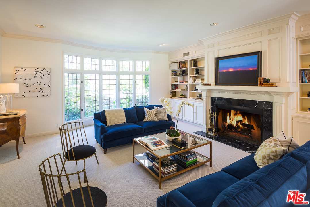 1420 Moraga Drive Los Angeles, CA 90049 - Photo 5 of 38 a living room with furniture and a fireplace