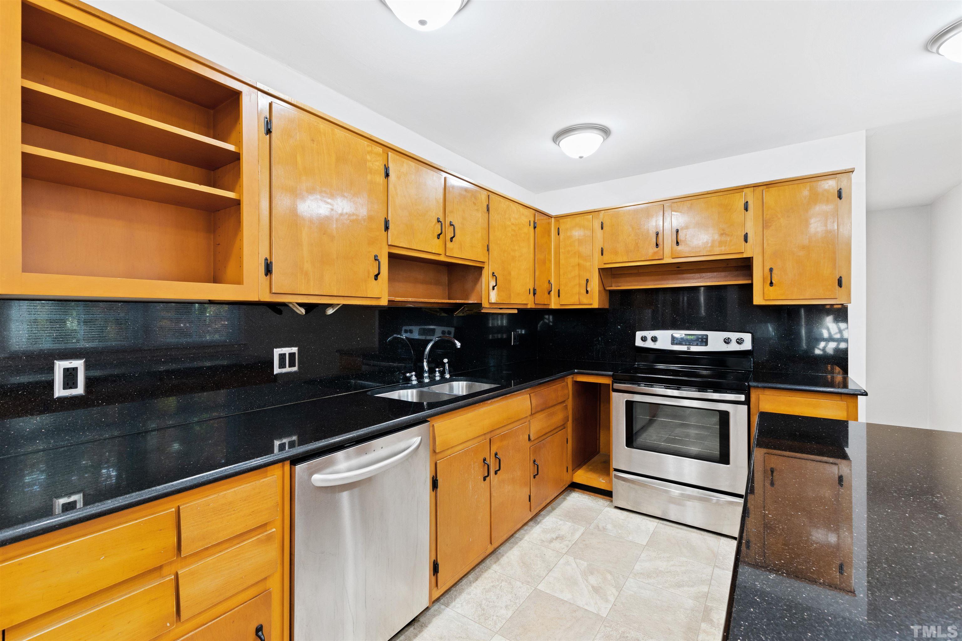 2209 Watkins Street Raleigh, NC 27604 - Photo 11 of 29 a kitchen with stainless steel appliances granite countertop a sink and a stove
