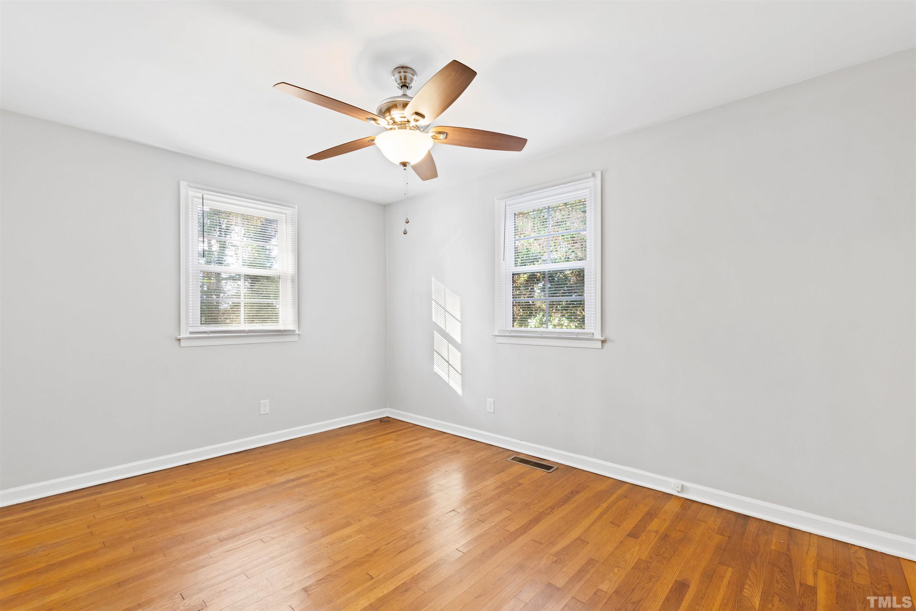 2209 Watkins Street Raleigh, NC 27604 - Photo 17 of 29 a view of an empty room with wooden floor and a window