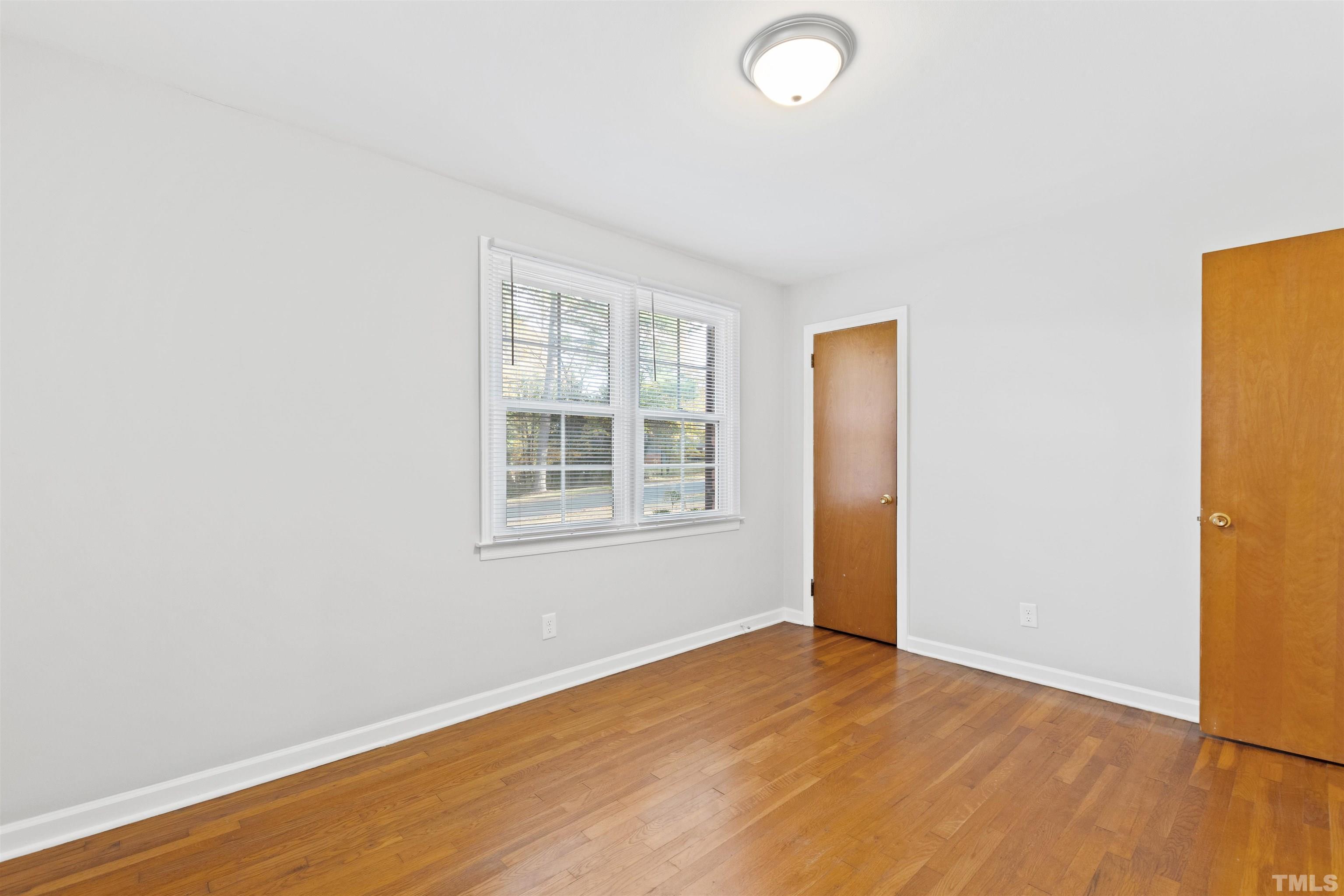 2209 Watkins Street Raleigh, NC 27604 - Photo 18 of 29 an empty room with wooden floor and windows