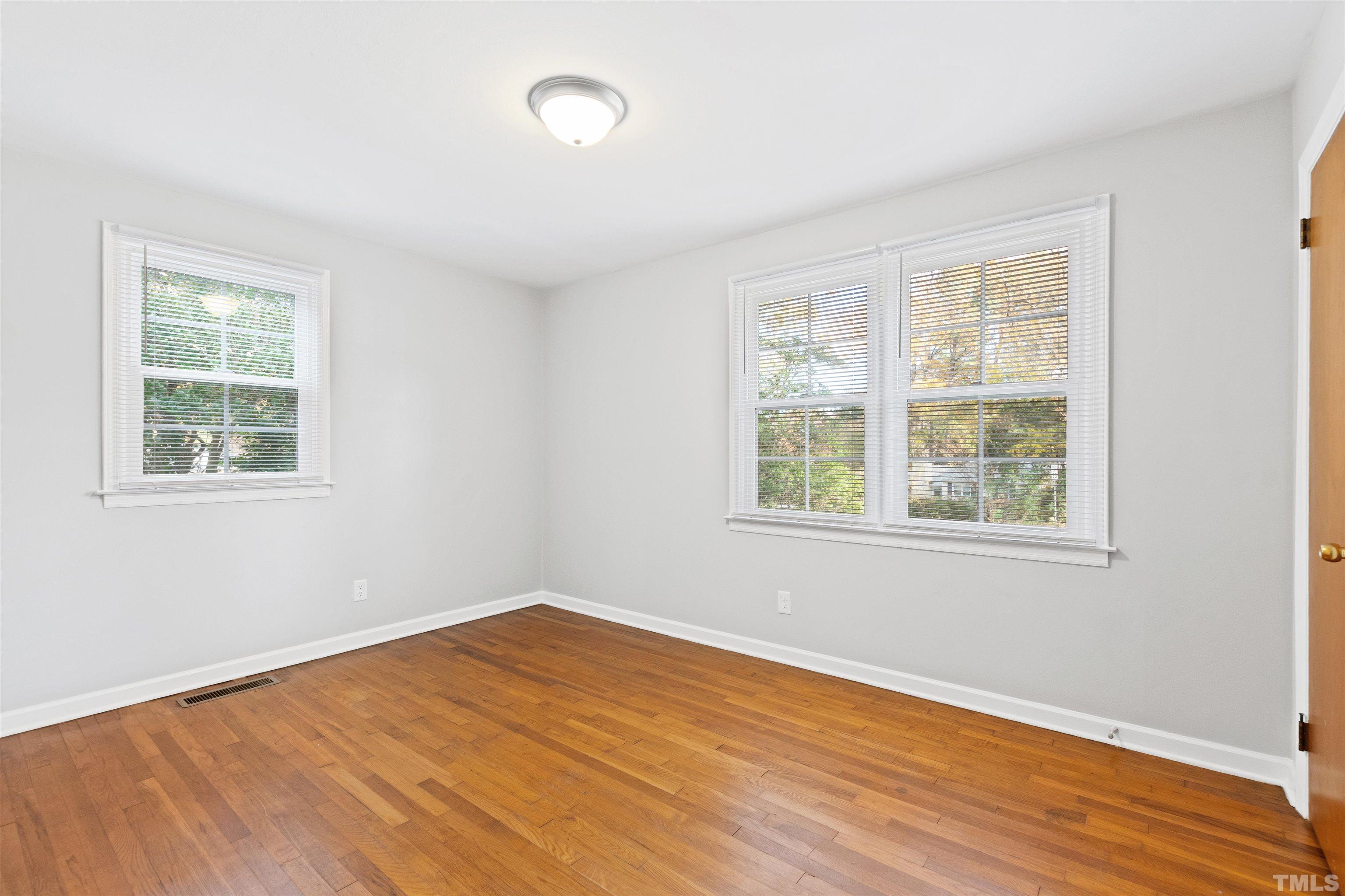2209 Watkins Street Raleigh, NC 27604 - Photo 19 of 29 an empty room with wooden floor and windows