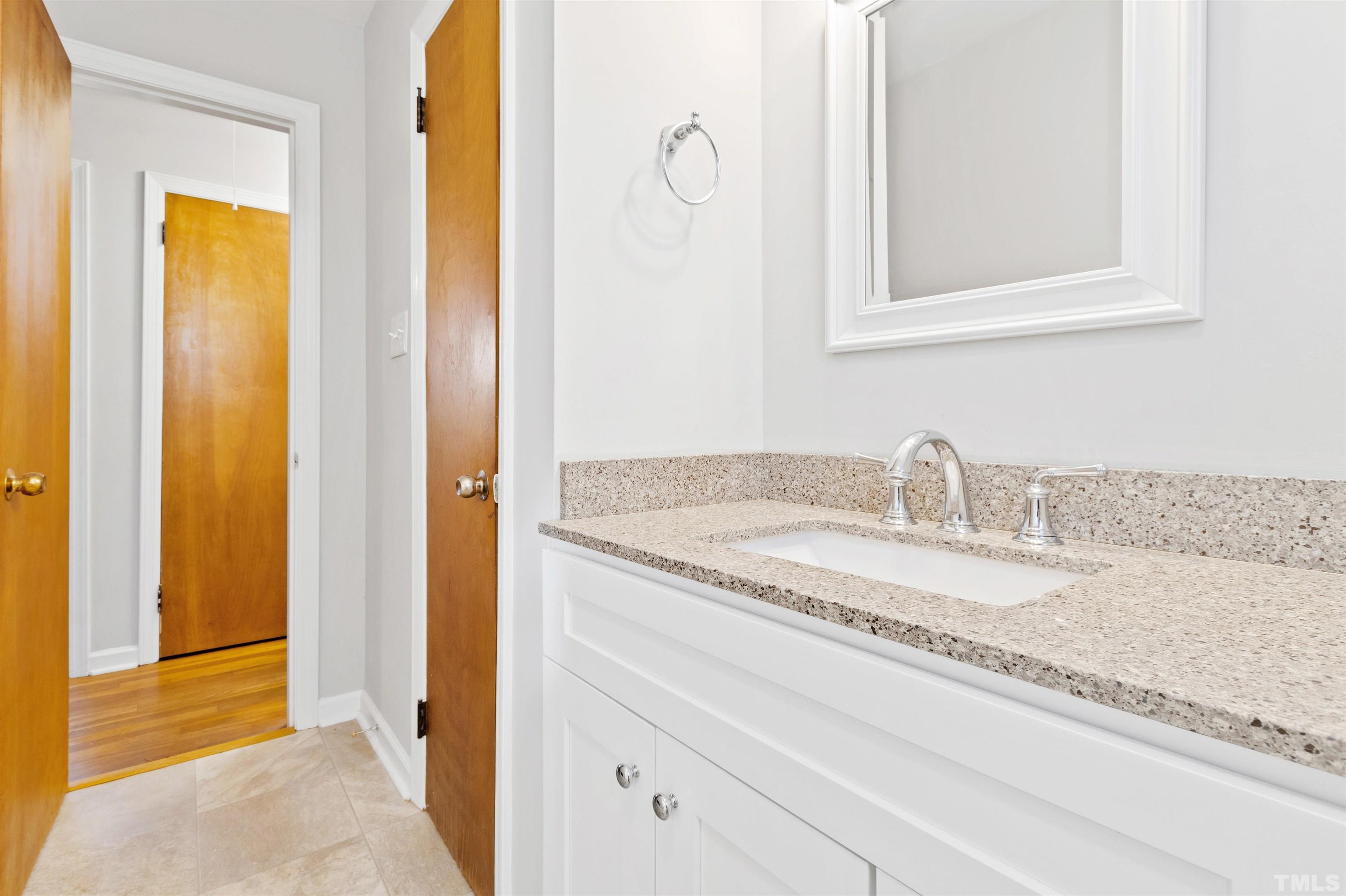 2209 Watkins Street Raleigh, NC 27604 - Photo 22 of 29 a bathroom with a granite countertop sink and a mirror