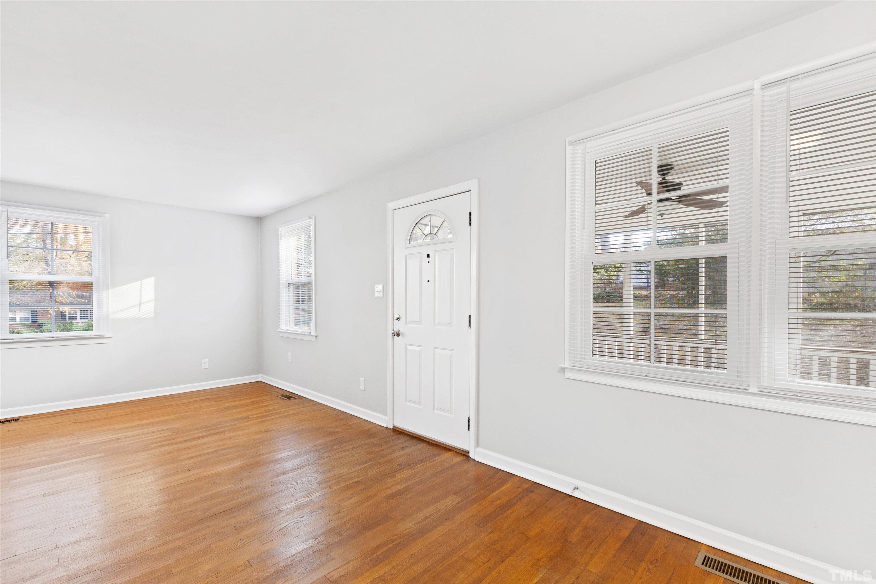2209 Watkins Street Raleigh, NC 27604 - Photo 4 of 29 an empty room with wooden floor and windows