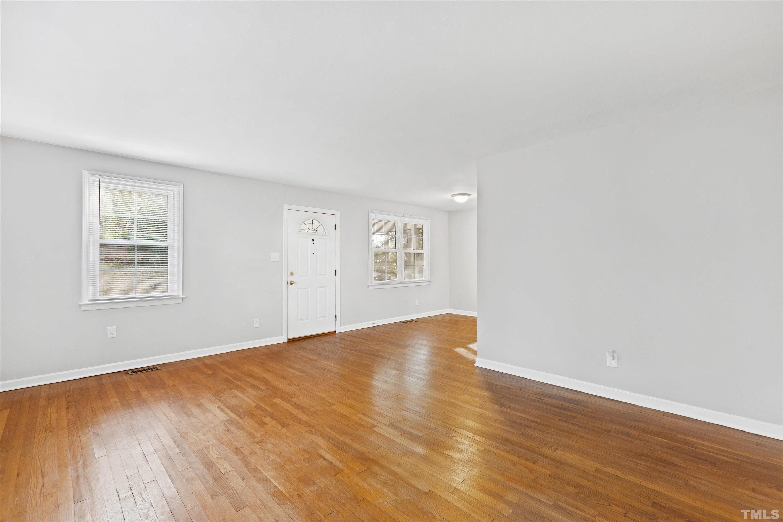2209 Watkins Street Raleigh, NC 27604 - Photo 6 of 29 an empty room with wooden floor and windows