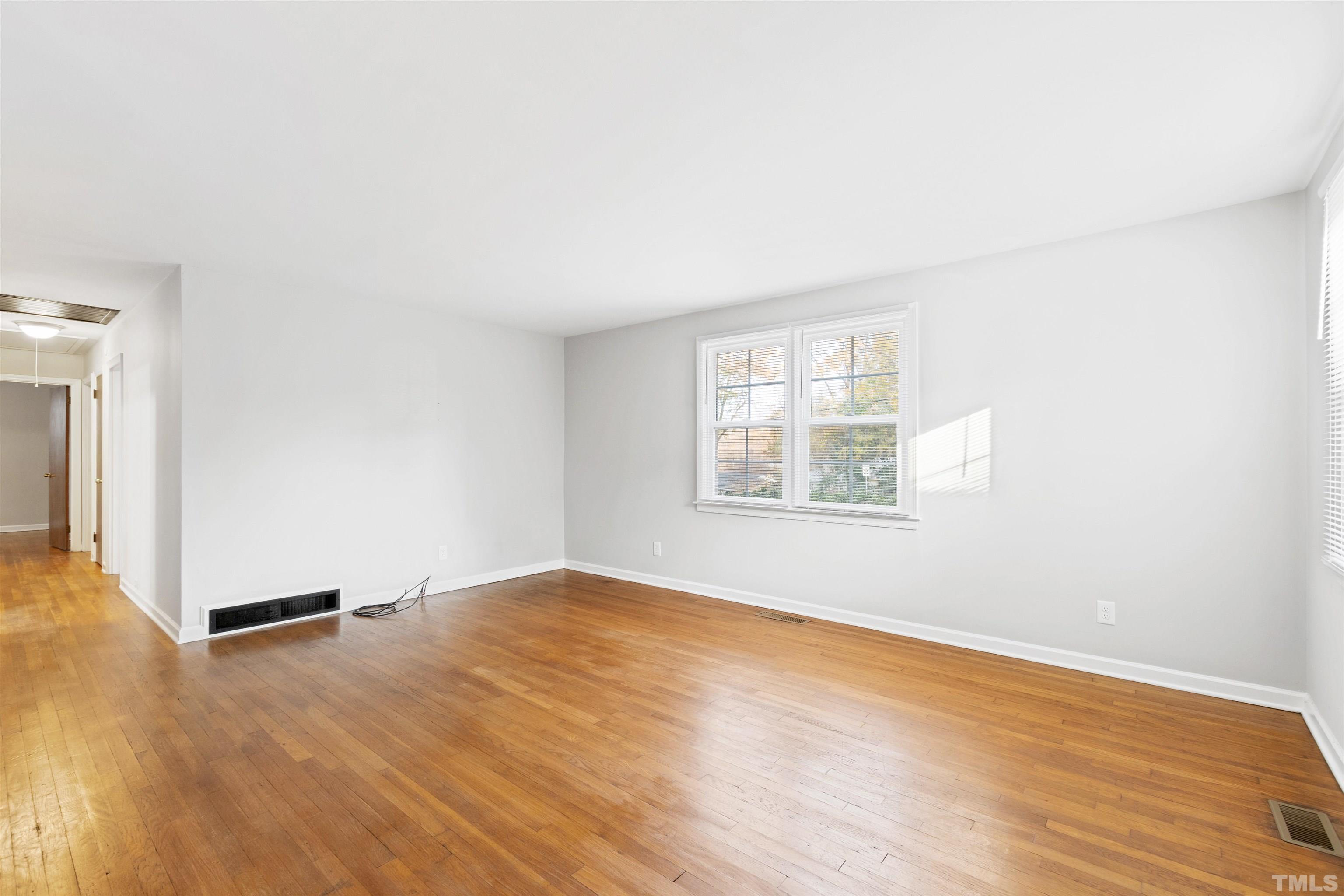 2209 Watkins Street Raleigh, NC 27604 - Photo 7 of 29 an empty room with wooden floor and windows