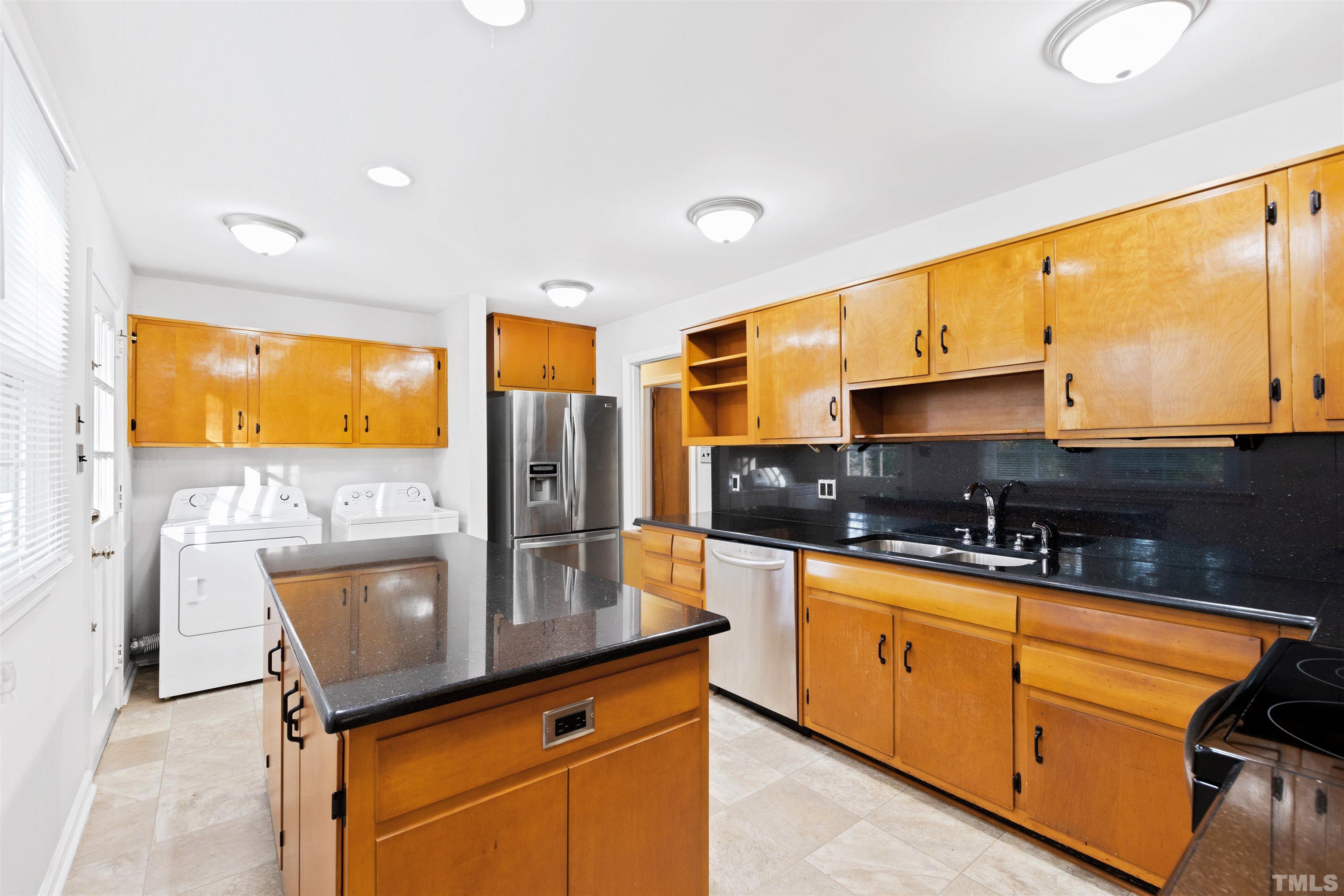 2209 Watkins Street Raleigh, NC 27604 - Photo 8 of 29 a kitchen with stainless steel appliances kitchen island granite countertop a sink and cabinets