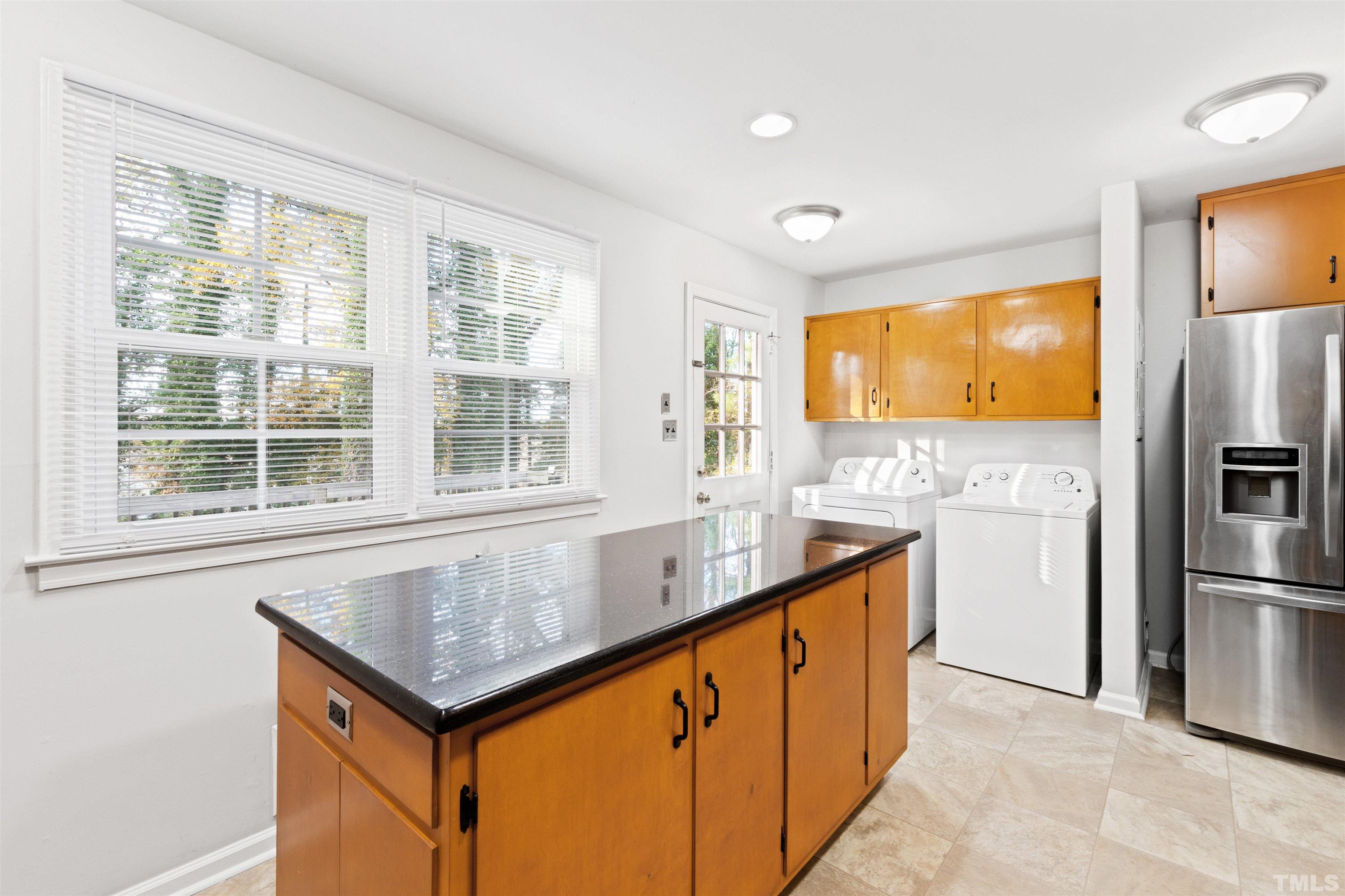 2209 Watkins Street Raleigh, NC 27604 - Photo 9 of 29 a kitchen with a sink window and refrigerator