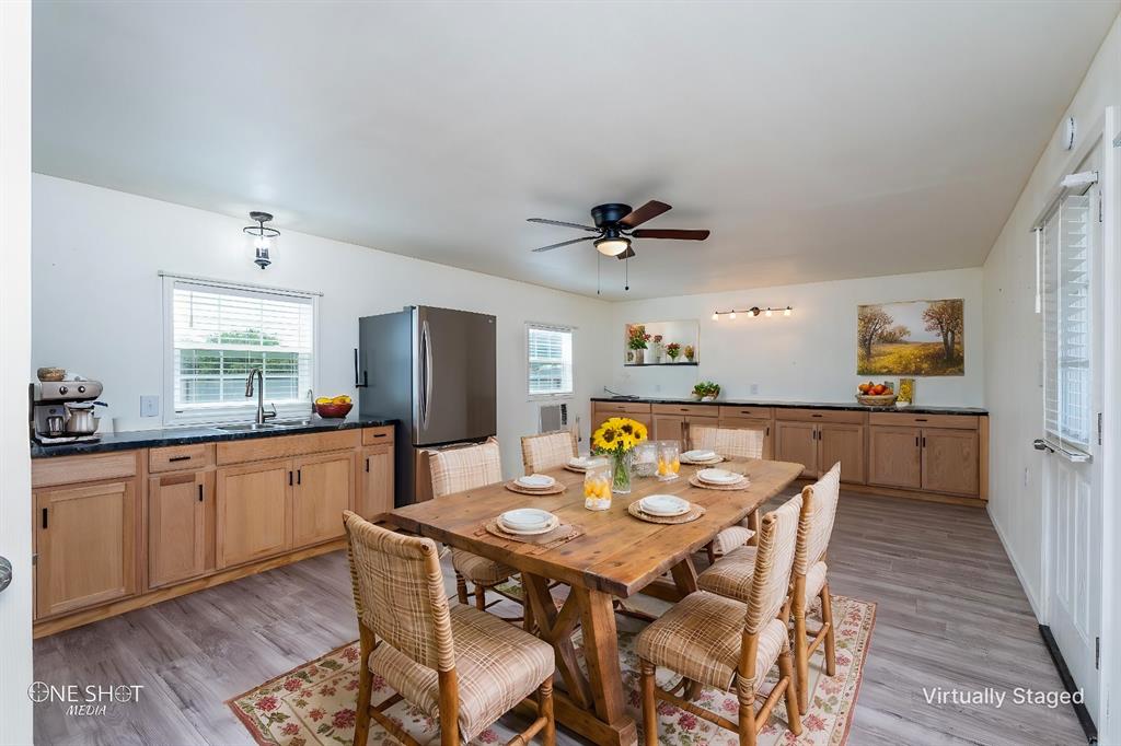 310 10th Street Hawley, TX 79525 - Photo 12 of 29 a kitchen with stainless steel appliances kitchen island granite countertop a sink a stove a dining table and chairs