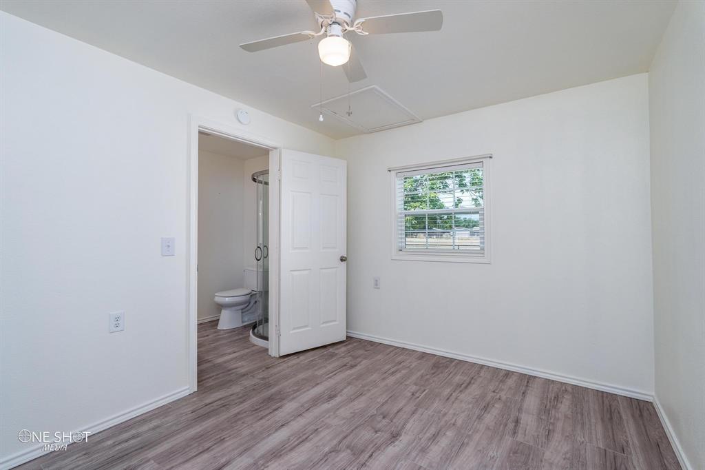 310 10th Street Hawley, TX 79525 - Photo 21 of 29 wooden floor in an empty room with a window