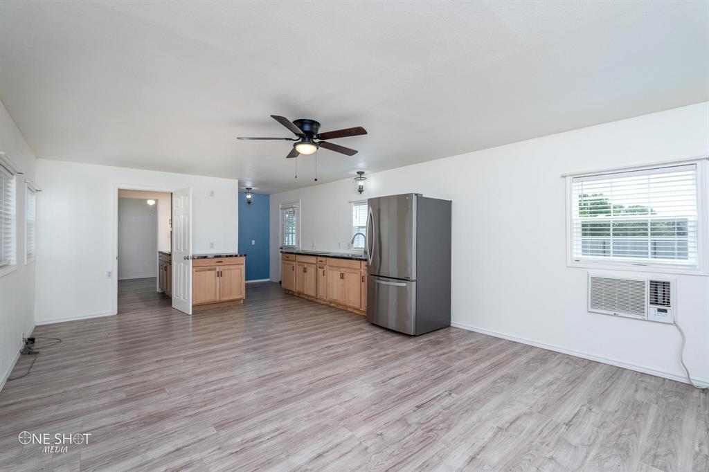 310 10th Street Hawley, TX 79525 - Photo 6 of 29 a view of a kitchen with refrigerator and wooden floor