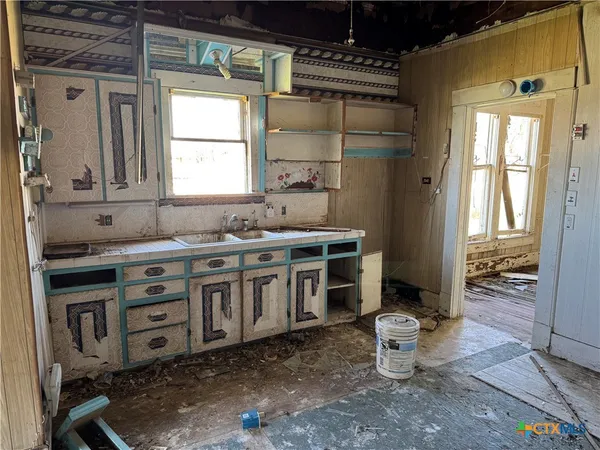 a kitchen with stainless steel appliances a stove a sink and a refrigerator