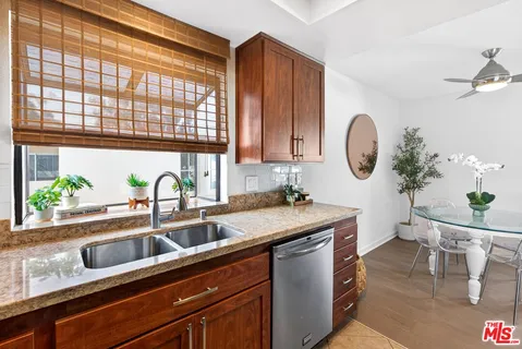 a kitchen with a sink cabinets and window