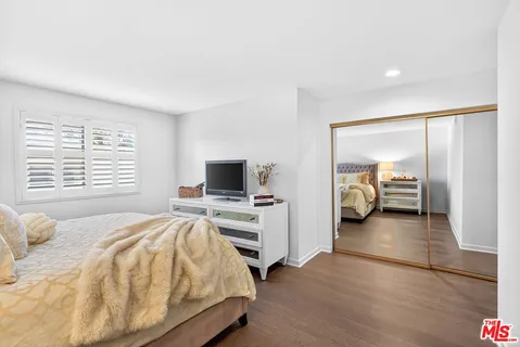 a bedroom with a bed and a television