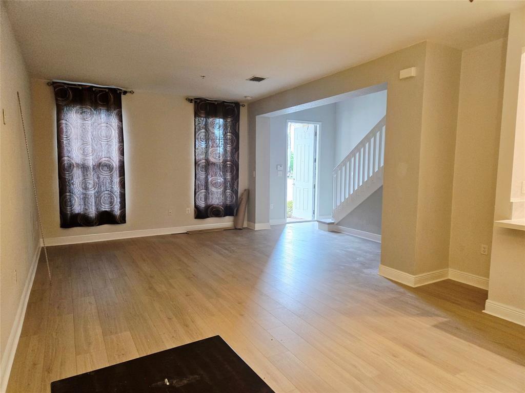 1528 Southwest 147th Avenue Pembroke Pines, FL 33027 - Photo 7 of 9 a view of an empty room with wooden floor and a window