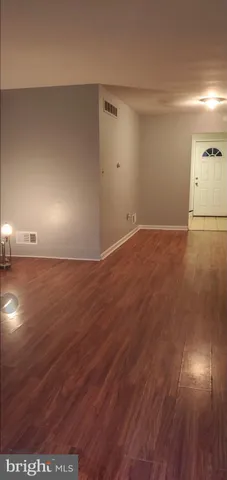 an empty room with wooden floor