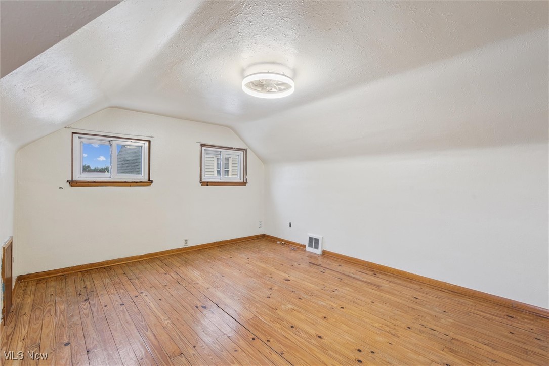 6234 Holburn Road Parma, OH 44129 - Photo 19 of 34 Bonus room featuring a textured ceiling, light wood-type flooring, and vaulted ceiling
