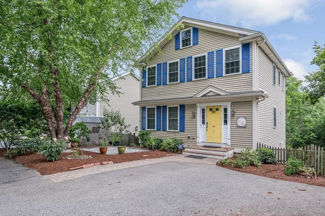 a front view of a house with a yard and a garage