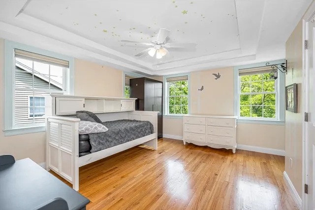 a bedroom with a large bed and wooden floor