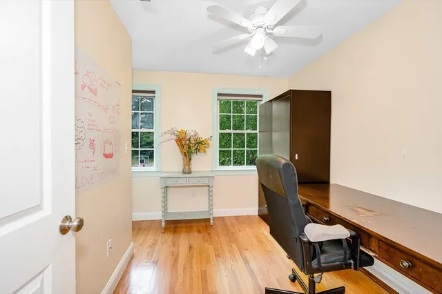 a view of a workspace with furniture and a window