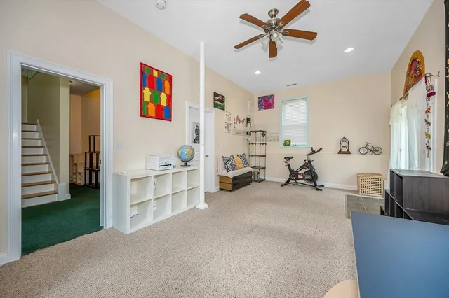 a view of a livingroom with furniture and a ceiling fan