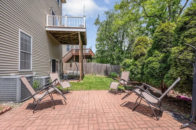 a view of a chairs and table in backyard of the house