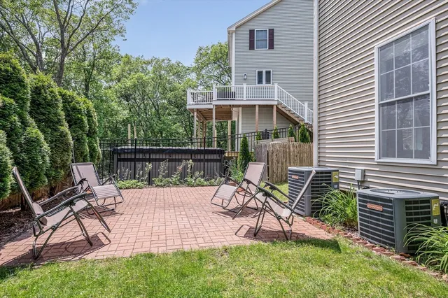 a view of a chair and table in backyard of the house