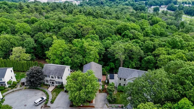 an aerial view of a house with a yard and outdoor seating