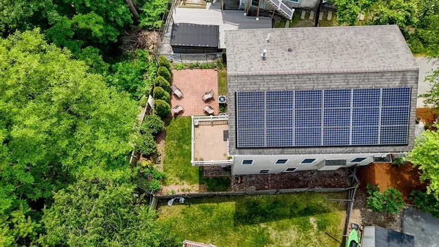 an aerial view of a house with a yard and lake view