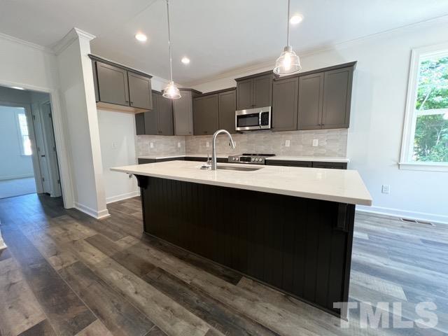 25 Pilot Ridge Road Zebulon, NC 27597 - Photo 5 of 16 a kitchen with kitchen island a sink appliances and cabinets