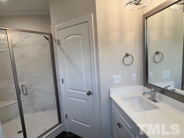 25 Pilot Ridge Road Zebulon, NC 27597 - Photo 8 of 16 a bathroom with a shower sink and mirror