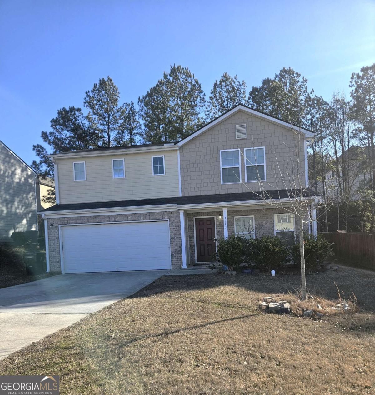 7313 Monastery Road Fairburn, GA 30213 - Photo 1 of 1 a front view of a house with a yard and garage