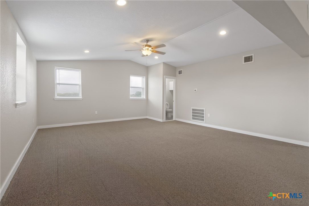 617 Bartlett Road Victoria, TX 77905 - Photo 23 of 30 an empty room with a window and a ceiling fan