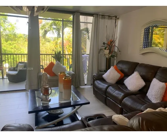 a living room with furniture and a floor to ceiling window