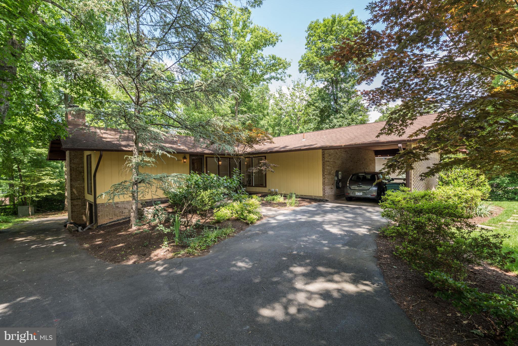 11302 Fairway Drive Reston, VA 20190 - Photo 1 of 30 a view of a house with potted plants and large trees