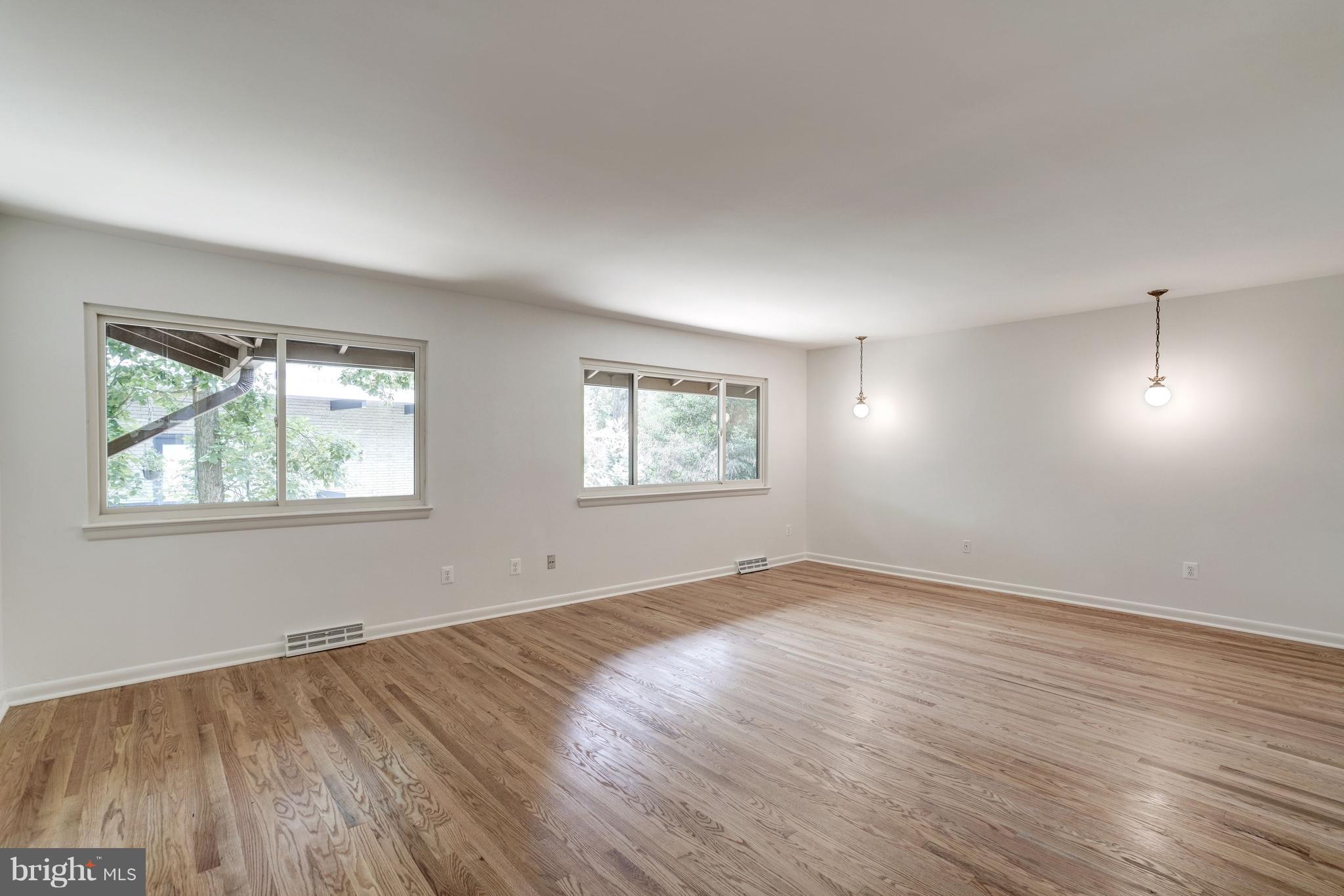 11302 Fairway Drive Reston, VA 20190 - Photo 14 of 30 an empty room with wooden floor and windows
