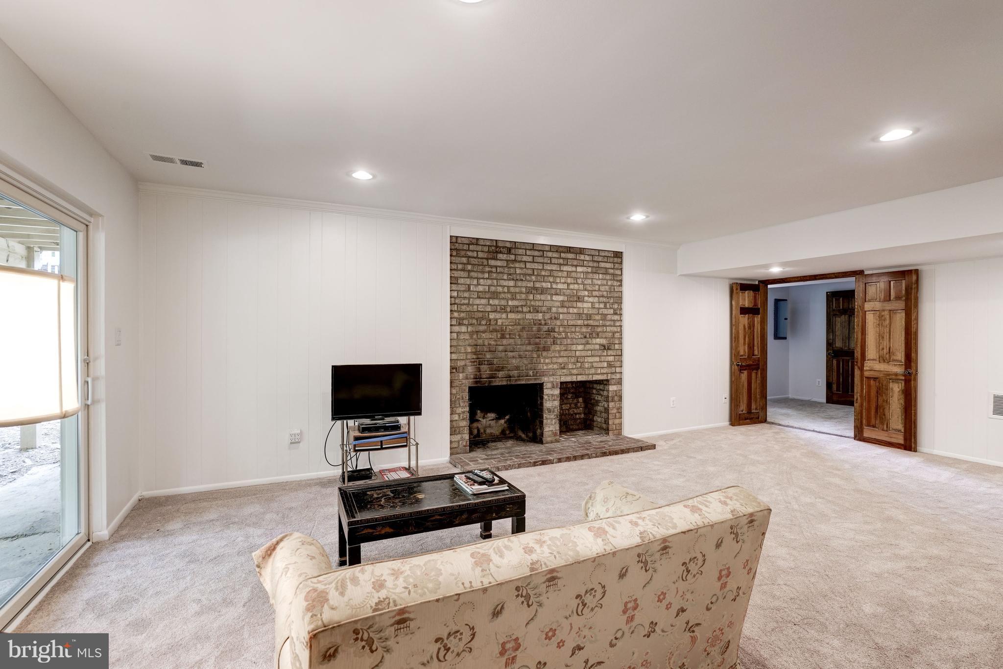 11302 Fairway Drive Reston, VA 20190 - Photo 17 of 30 a living room with furniture a flat screen tv and a fireplace
