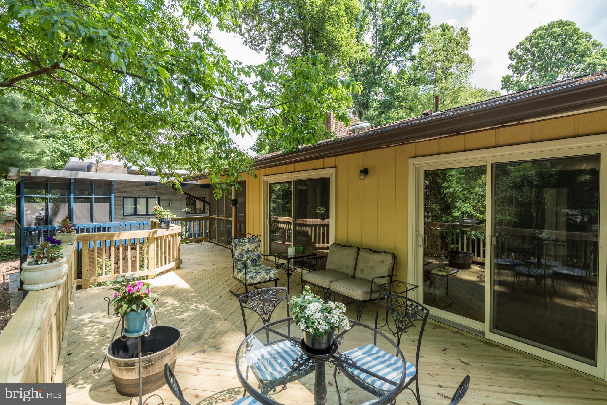11302 Fairway Drive Reston, VA 20190 - Photo 25 of 30 a view of a patio with couches table and chairs and potted plants