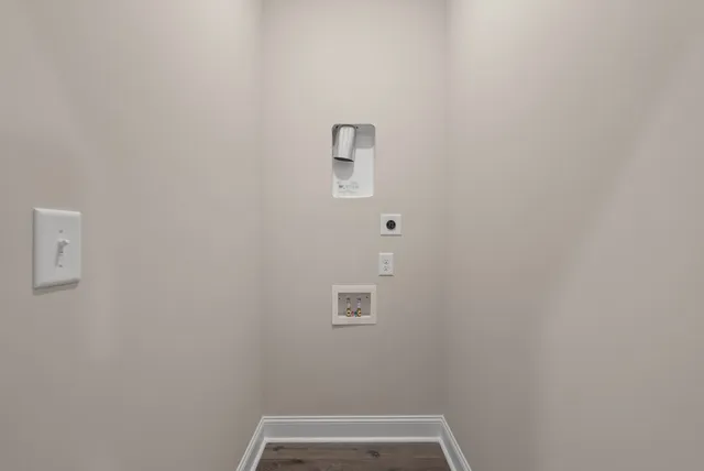 an empty room with wooden floor chandelier fan and windows