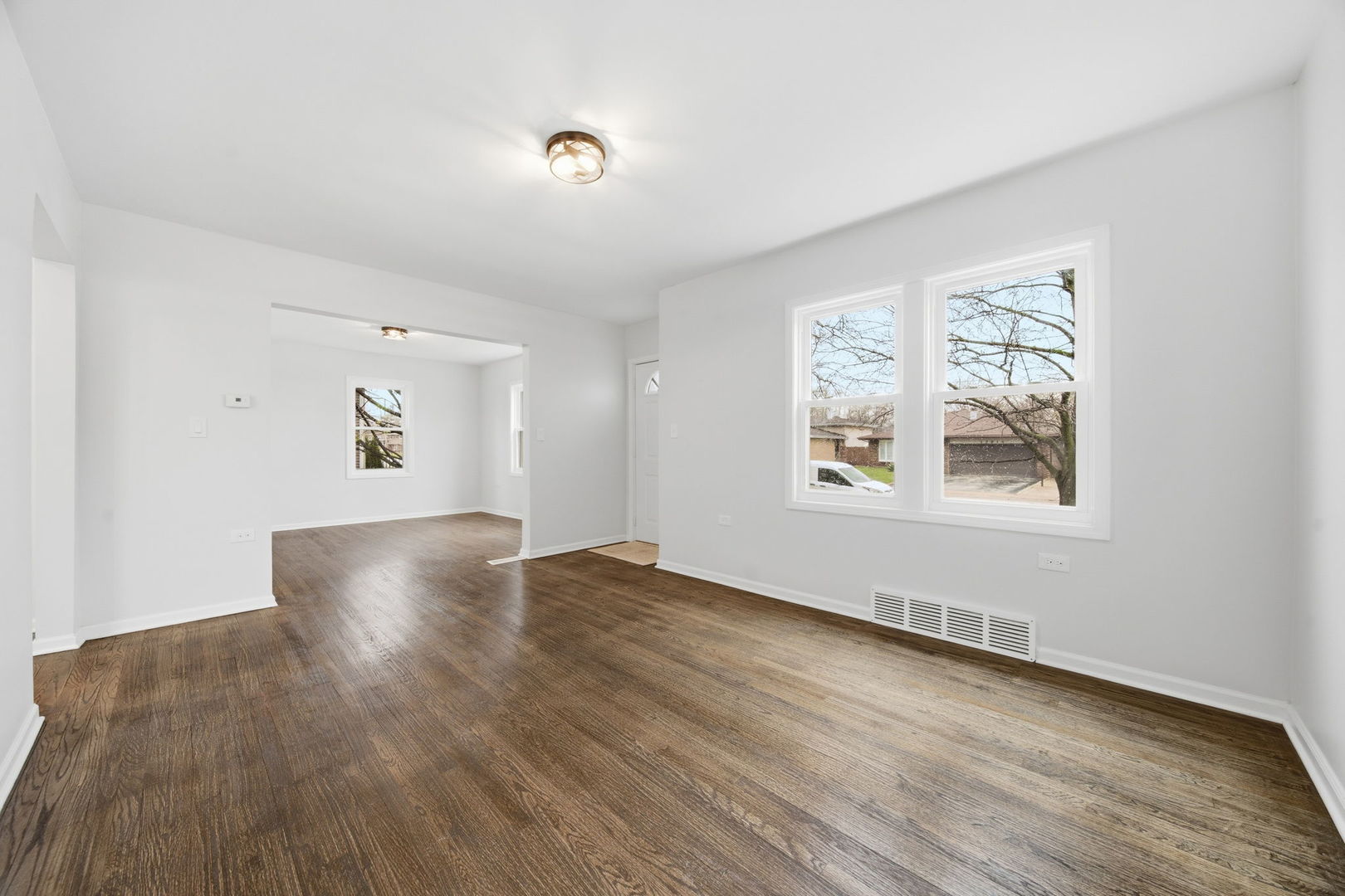 17909 Rose Street Lansing, IL 60438 - Photo 11 of 27 an empty room with wooden floor and windows