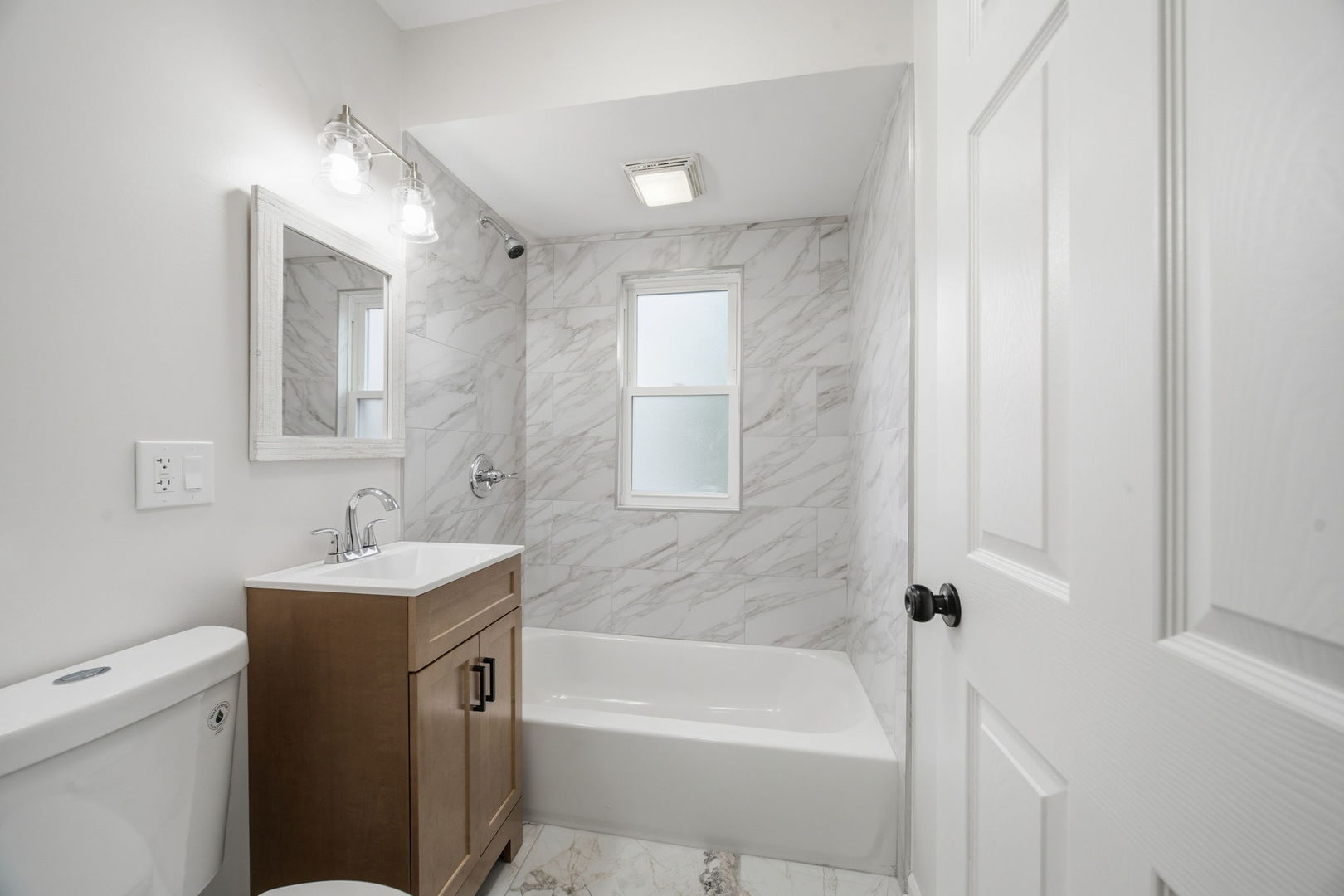 17909 Rose Street Lansing, IL 60438 - Photo 14 of 27 a bathroom with a sink mirror toilet and bathtub
